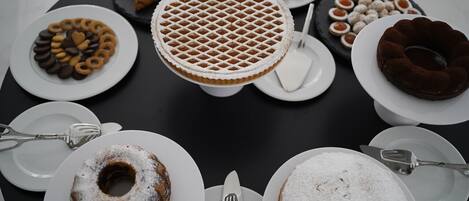 Una mesa con diversos postres y pasteles dispuestos en platos.