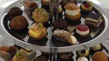 A multi-tiered dessert display with various pastries and sweets.
