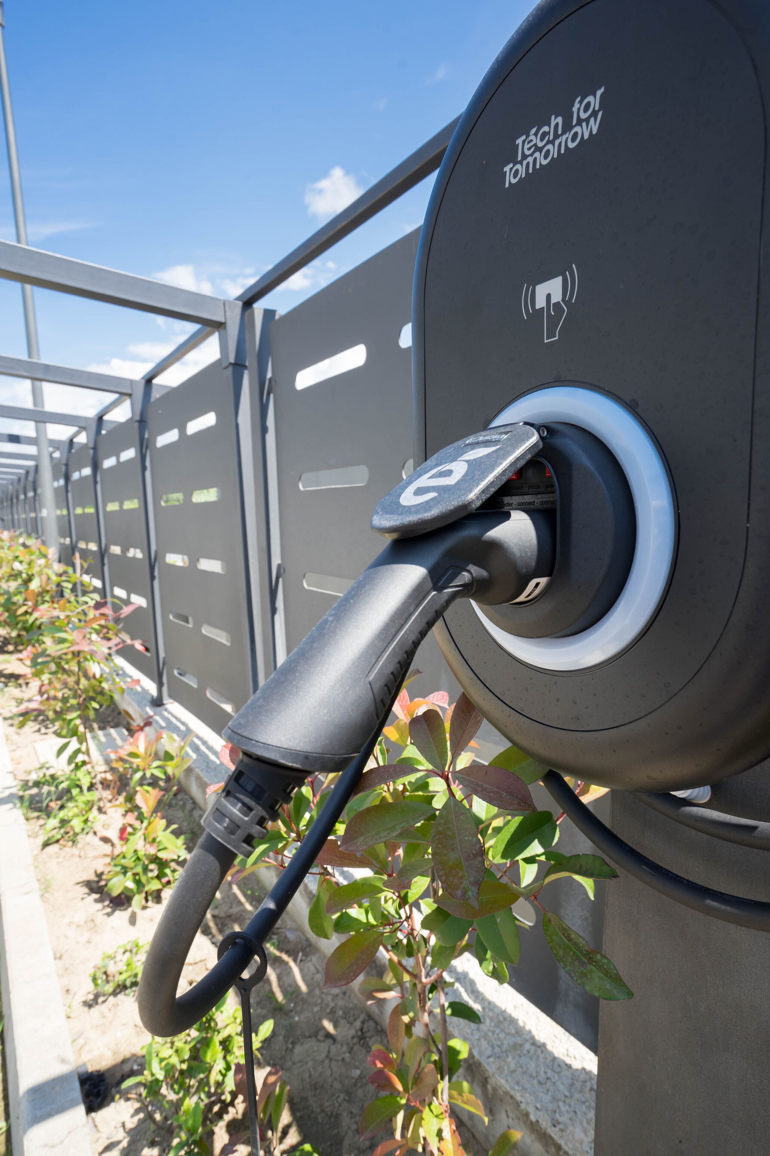 A charging station with a cable connected to a vehicle.