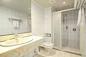 Een bad/douchecombinatie, een haardroger, handdoeken, shampoo