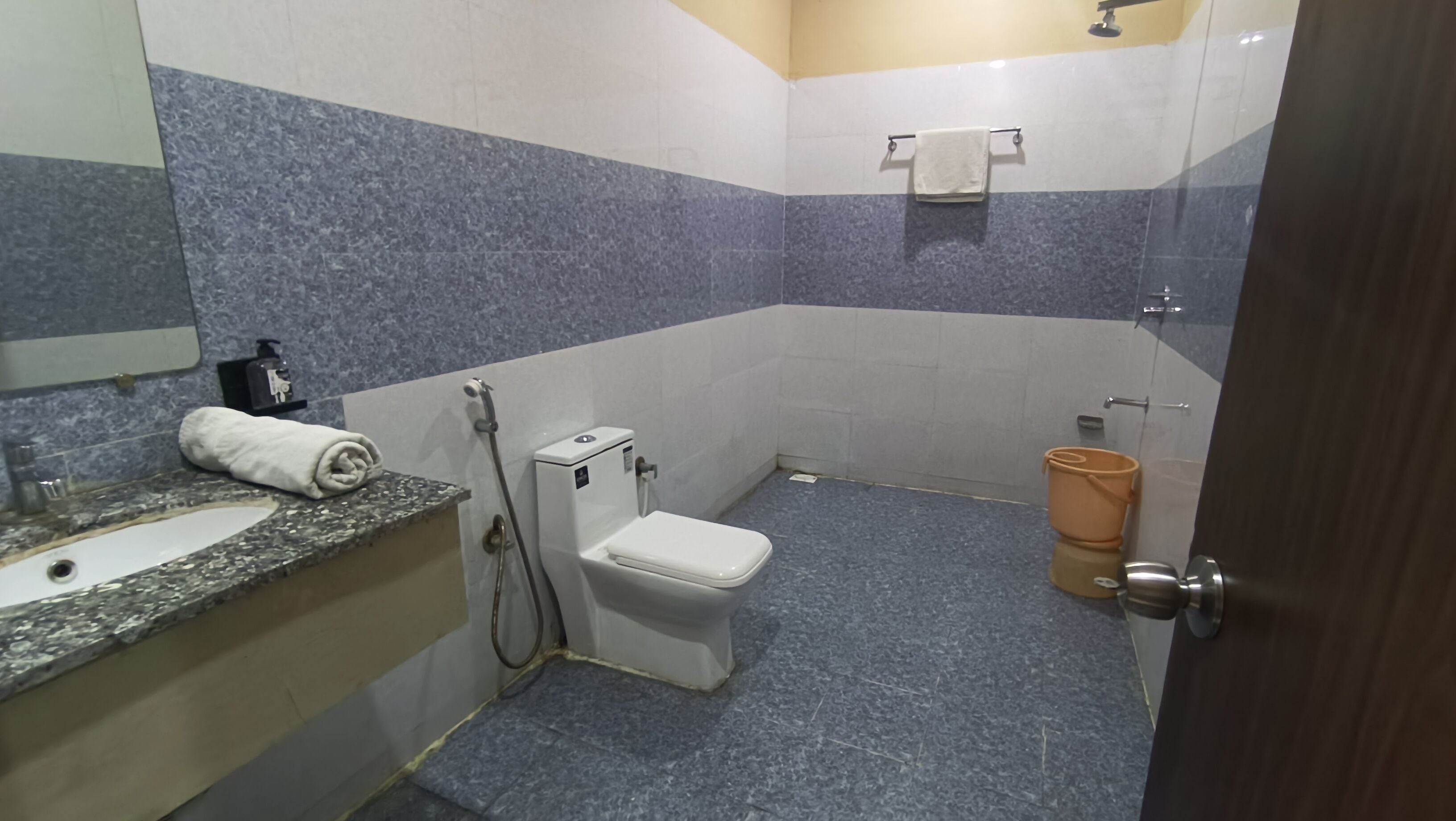 A bathroom with a sink, toilet, and shower.