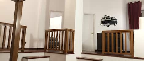 A staircase with wooden railings leading to a landing.