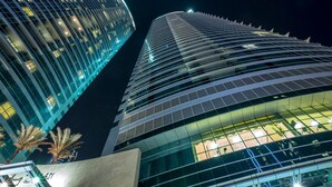 Two modern high-rise buildings with reflective glass facades and a night sky background. - Al Fattan - Sea View - Luxury JBR - Free Beach Resorts Access! (Dubai)