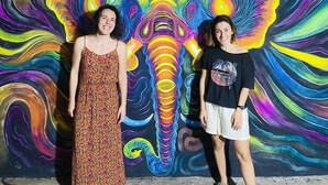 Two individuals standing in front of a colorful mural. - The Kingslayer Resort  (Negombo)