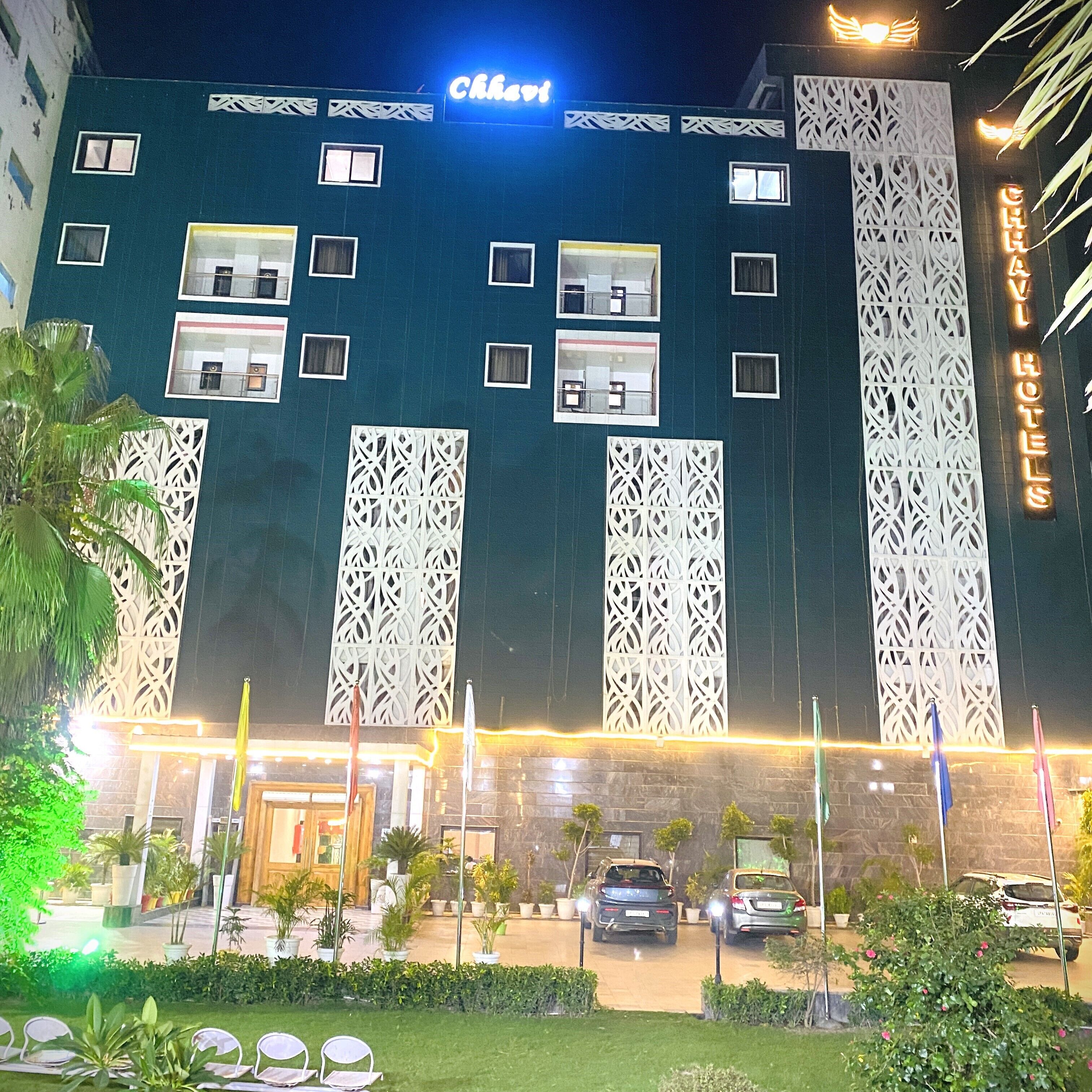 A hotel with a modern facade, multiple windows, and a sign indicating it is a hotel.