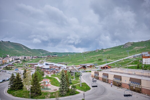 A town with a ski lift, buildings, and a road.