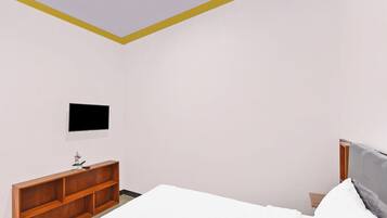 A bedroom with a bed, a wooden nightstand, a television mounted on the wall, and a small shelf with a plant.