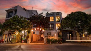 A hotel entrance with a modern design, a gated driveway, and a sign reading "Las Santas Villas." - LaSanta Villa (Da Nang)