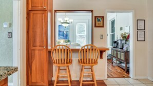 A kitchen with wooden cabinets, a double sink, and two wooden bar stools. - Walk to Crown Zellerbach Trl: PNW 'Celestial Inn' (Scappoose)