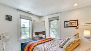A bedroom with a bed, a bedside fan, a window with blinds, a framed picture on the wall, and a ceiling fan. - Walk to Crown Zellerbach Trl: PNW 'Celestial Inn' (Scappoose)