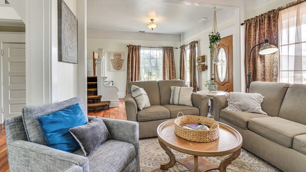 A spacious living room with a grey sofa, a blue armchair, and a wooden coffee table. - Walk to Crown Zellerbach Trl: PNW 'Celestial Inn' (Scappoose)
