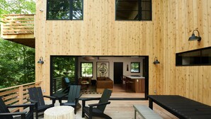 A wooden deck with outdoor seating, a wooden deck with a view of the interior, and a wooden deck with a view of the exterior.