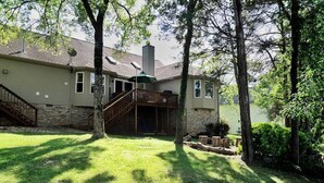 A two-story house with a covered porch, a staircase, and a brick chimney.