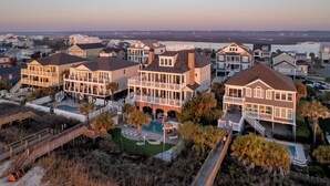 A coastal residential area with multiple houses featuring large balconies, a swimming pool, and a beach access walkway. - Grey Goose: Oceanfront Escape, Backyard Oasis + Prime Location (Murrells Inlet)
