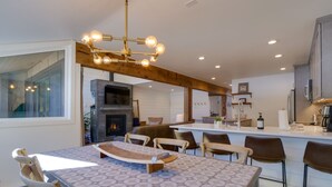 A modern kitchen with a central island, bar stools, and a hanging light fixture. - BEST LOCATION! Ski-In Ski-Out - Copper Mt - HotTub, Sleeps 8 (Frisco)