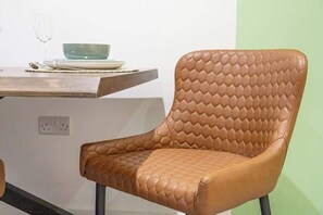 A modern chair sits in front of a simple table, perfect for dining or meeting.