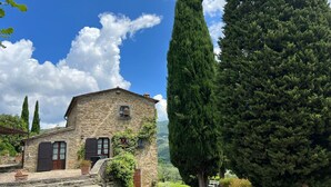 A stone building with a small porch and a window with a flower box. - Villa in Sant'angiolo with 5 bedrooms sleeps 12 (Sant'angiolo)