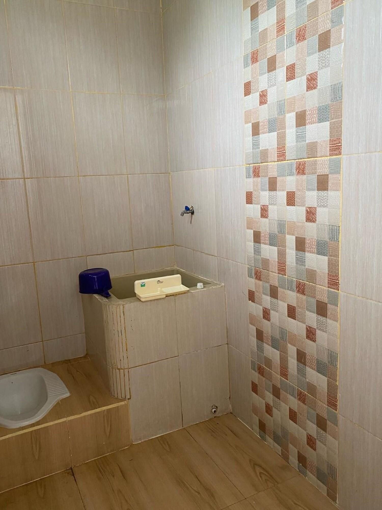 A bathroom with a shower, a sink, and a toilet.