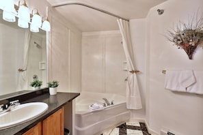 A bathroom with a sink, mirror, shower, and bathtub. - The Birch Ridge: Blue Velvet Room #10 - Queen Suite in Killington, Vermont. Hot Tub. Lounge. (Killington)