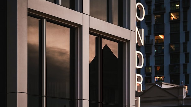 A modern building with large windows and the name "MONDRIAN" illuminated on the facade. - Mondrian Singapore Duxton (Singapore)