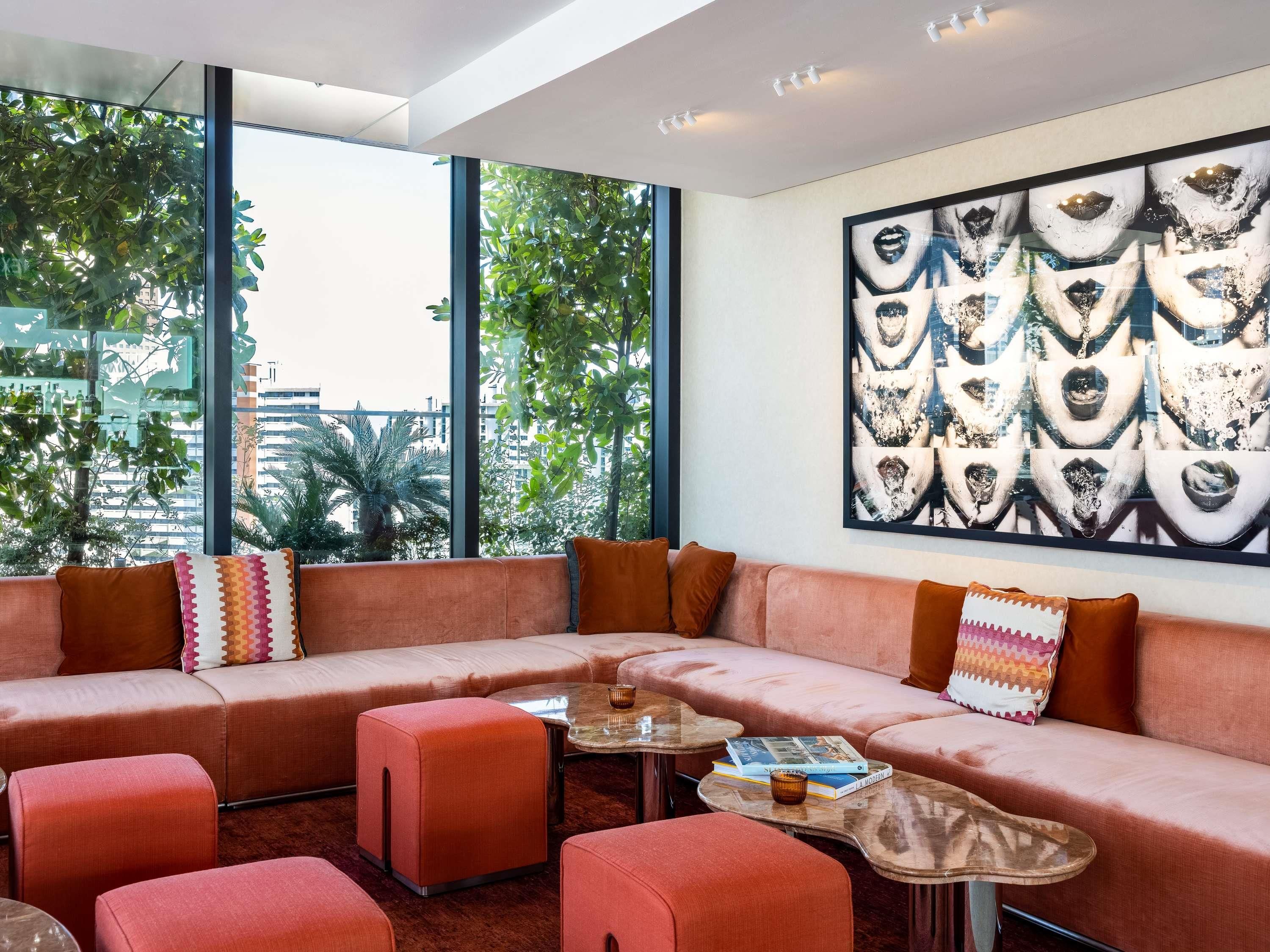 A modern living room with a sectional sofa, ottomans, and a coffee table.