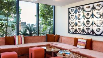 A modern living room with a sectional sofa, ottomans, and a coffee table.