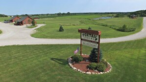 A sign for Foxtail Cabins advertising daily and weekly rentals, golf, fishing, and relaxing. - Pheasant - Dog-Friendly - Sleeps up to Four (Moravia)