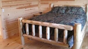 A wooden cabin interior with a bed, wooden walls, and a simple layout. - Pheasant - Dog-Friendly - Sleeps up to Four (Moravia)