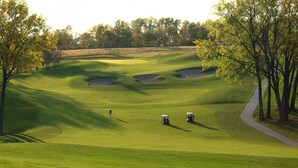 A golf course with a clear path, sand bunkers, and trees. - Walleye -  Sleeps up to Five (Moravia)