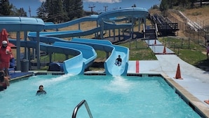 A water park with multiple slides and a swimming pool. -  AC, Walk 2 Lake, Go Karts, Dining & Shops, King Bed, 55" TVs+Fenced Yard 4 Pet! (Big Bear)
