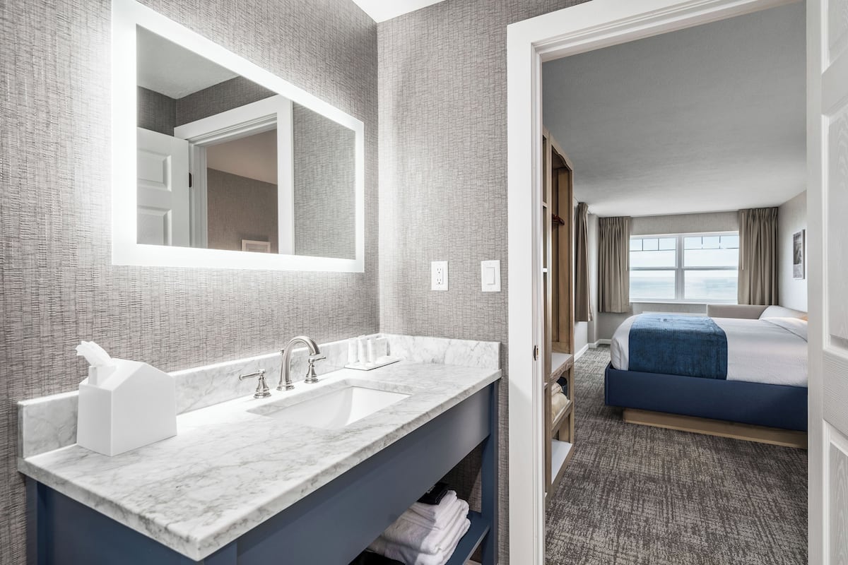 Lakeview Corner King Room | Bathroom | Designer toiletries, hair dryer, towels, soap