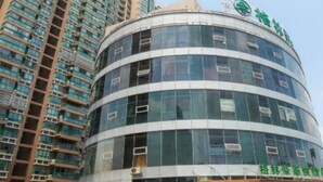 A modern building with a curved facade and multiple windows. - Greentree Inn Wuxi New District High Speed Rail Station Newland Family Express Hotel (Wuxi)