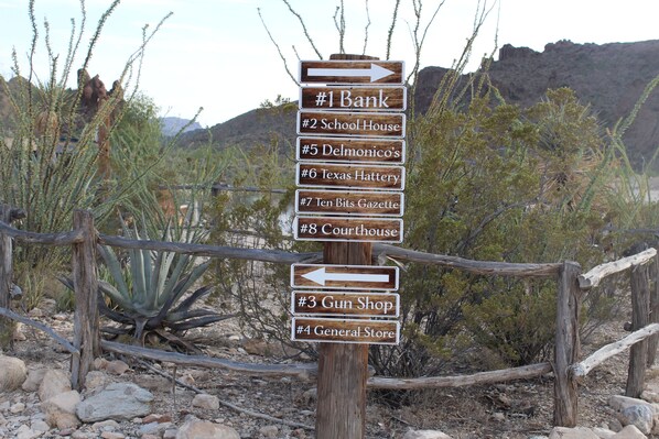 A directional signpost with arrows pointing to various local businesses.
