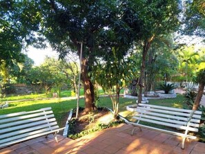 Relax in a serene outdoor space surrounded by lush greenery and tranquil surroundings.