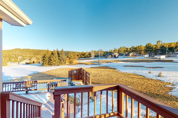 Enjoy a serene view from the deck overlooking the snow-covered landscape.