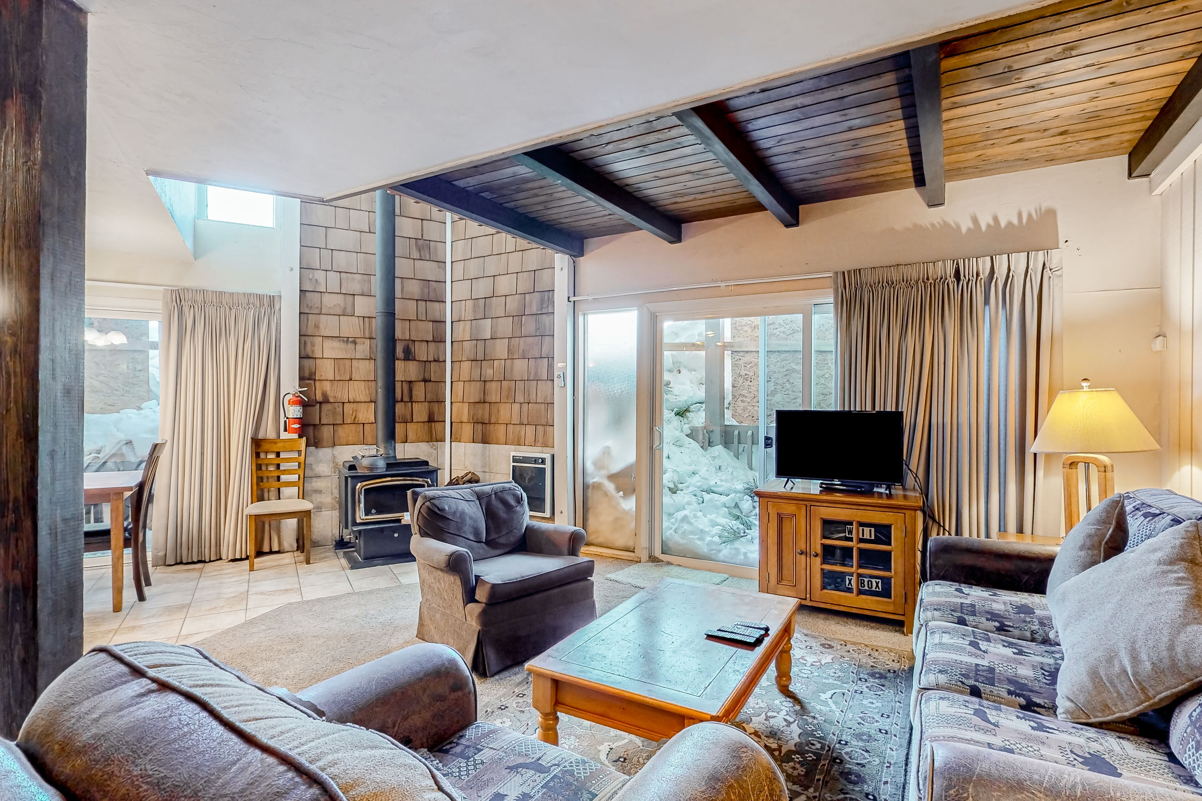 Affable condo with fireplace, hot tub, sauna, deck, W/D, kitchen, & wood stove