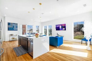 Enjoy cooking in this well-equipped kitchen with a central island, sink, and range hood.