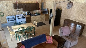 A compact living space with a kitchenette, dining area, and seating. - Lake front Rustic Cabin in the UP, Snowmobile-ATV trails, Falls, Mackinaw Island (Trout Lake)