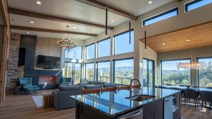 A spacious kitchen with a large island, built-in appliances, and a view of the mountains. - Luxury Family and Friends Getaway, Indoor Pool, Theater, Epic Smoky Mtn Views (Sevierville)