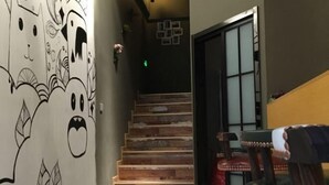A staircase with wooden steps leading to a door with frosted glass panels. - Pian an Yi Yu (Chizhou)