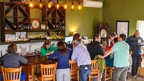 Enjoy a drink at the bar, surrounded by comfortable seating and a selection of beverages.