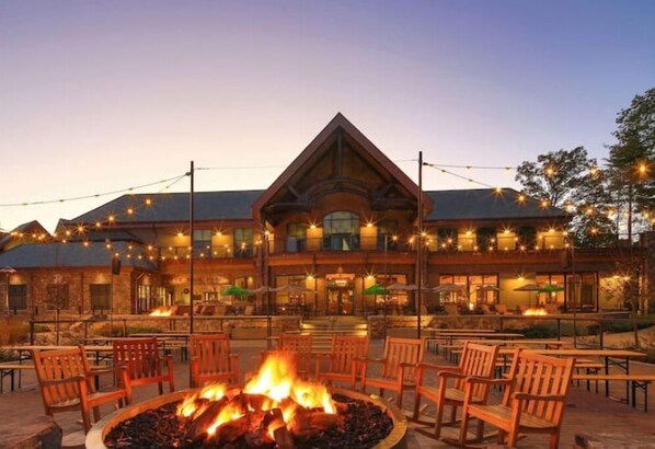 Relax by the central fire feature in this inviting outdoor seating area, surrounded by comfortable chairs.