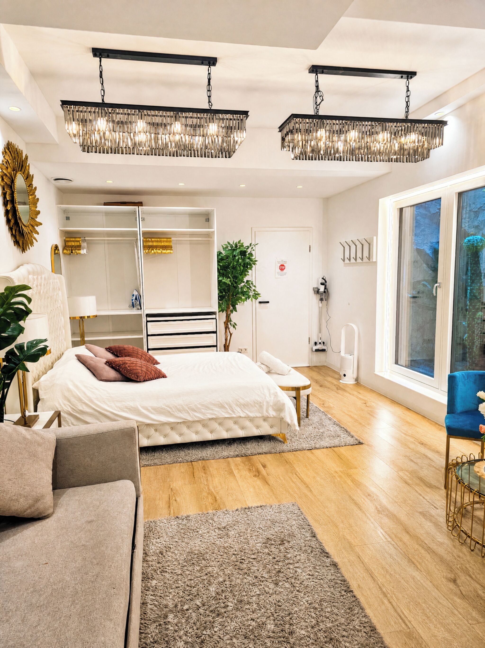 Ein modernes Schlafzimmer mit einem großen Bett, einer Sitzecke und Blick ins Freie.