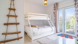 A room with a bunk bed, a ladder, a hanging light fixture, a window with curtains, and a rug. - Luxurious home in Viñuela (Viñuela)