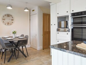 A kitchen with white cabinets, a built-in microwave, and an oven. - 5 bedroom accommodation in Warton, near Lytham (Warton, near Lytham)