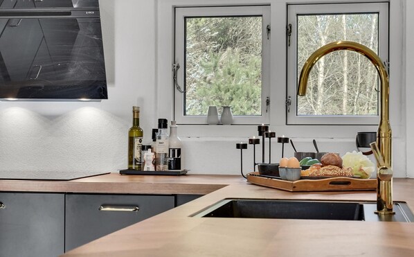 Enjoy cooking in this kitchen with a central island, stainless steel sink, and appliances.