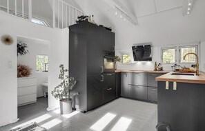 Enjoy cooking in this well-lit kitchen with a central island, sink, and oven.