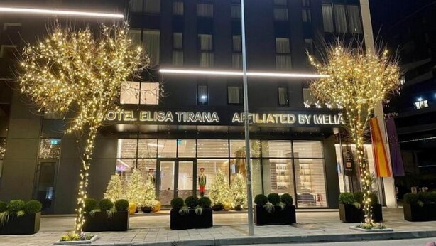 The exterior of Hotel Elisa Tirana, featuring illuminated trees and a modern facade. - Elisa Hotel Tirana Affiliated By Melia (Tirana)