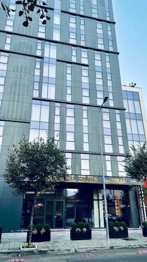 A modern building with a glass facade and a sign reading "Hotel Elisa." - Elisa Hotel Tirana Affiliated By Melia (Tirana)