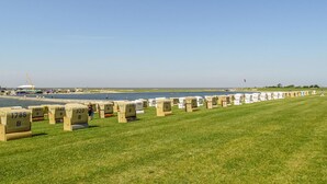 A grassy area with numbered concrete blocks arranged in rows. - 1 bedroom amazing apartment in Büsum (Büsum)